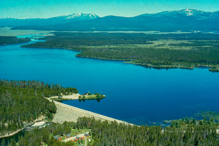 Aerial photo of Island Park Reservoir. The dam is in the bottom left corner. The Centennial Mountain Range is in the top.