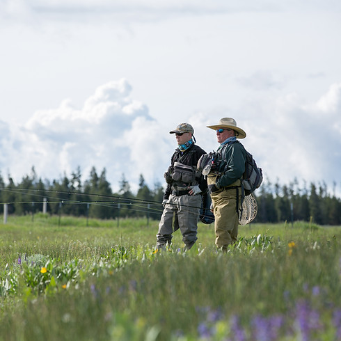 two men standing in field
