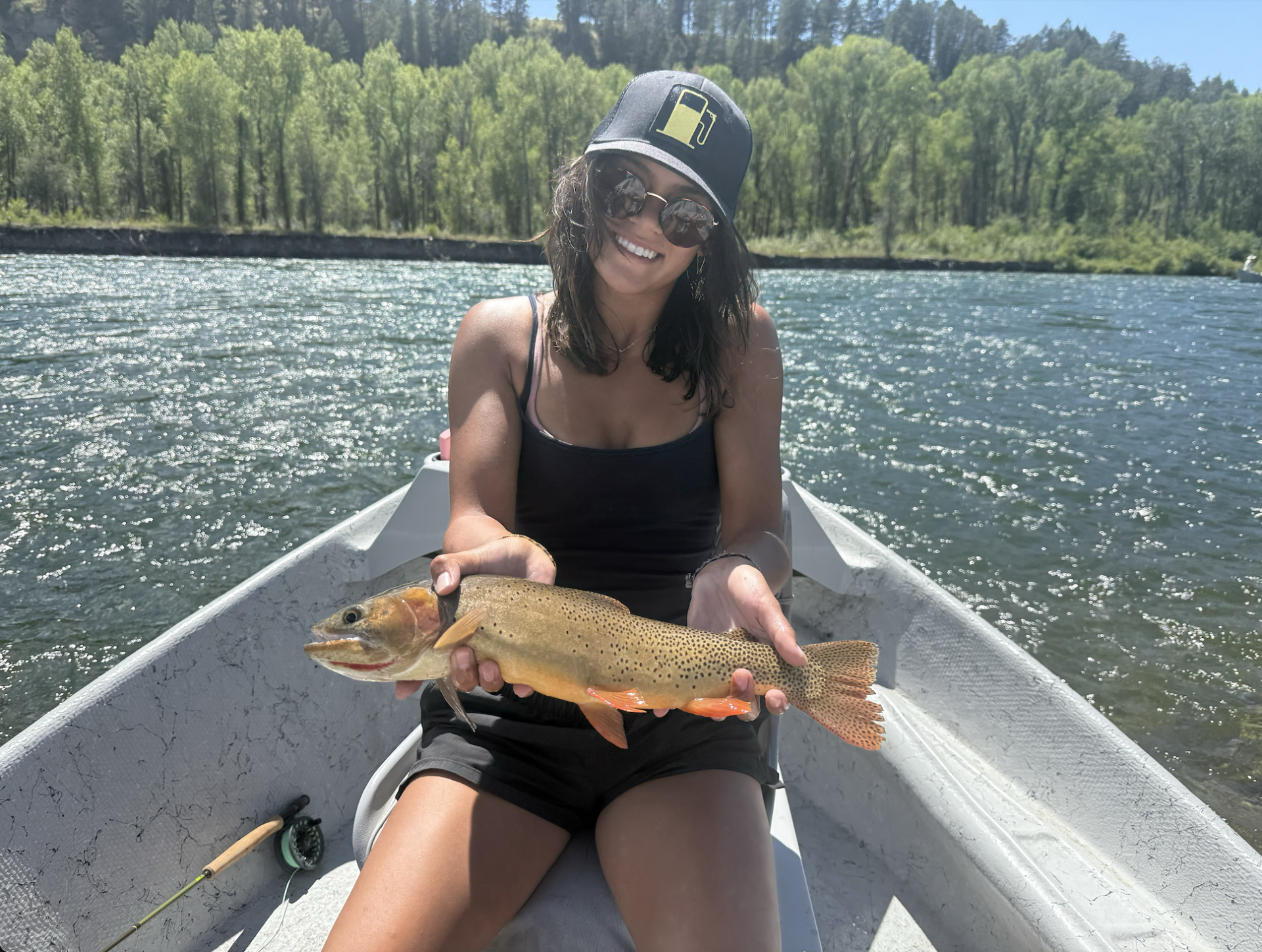 woman smiling holding a fish