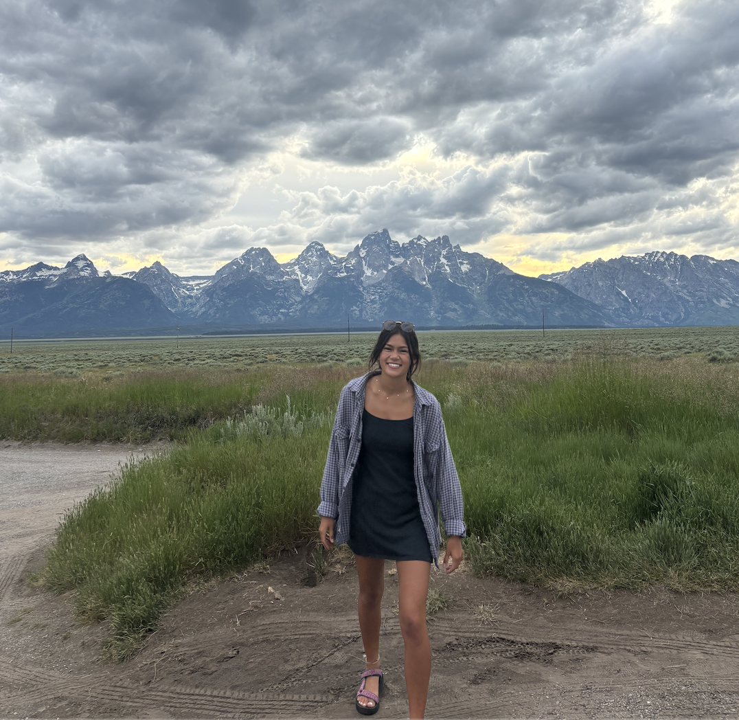 Woman Smiling in from of the Teton Mountains