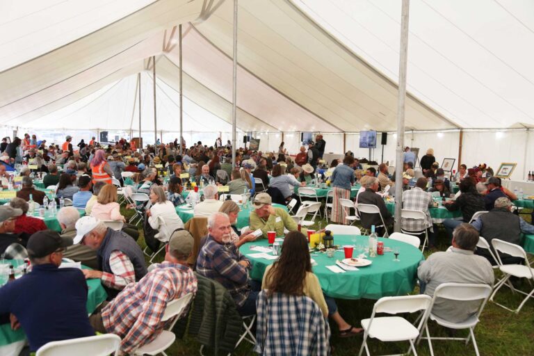 people in a large white tent
